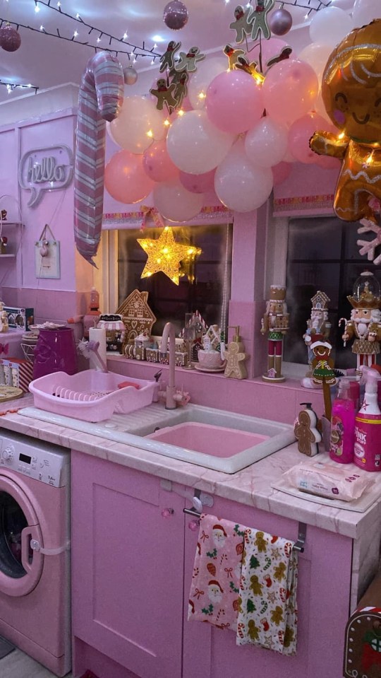 a kitchen with pink cabinets and a sign that says hello