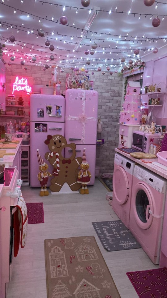 a pink smeg refrigerator with a neon sign that says let 's party