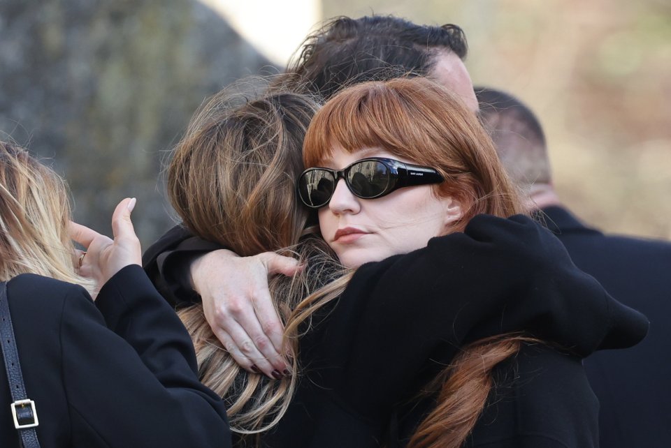 Nicola Roberts hugged other mourners as they joined a crowd gathering outside the church