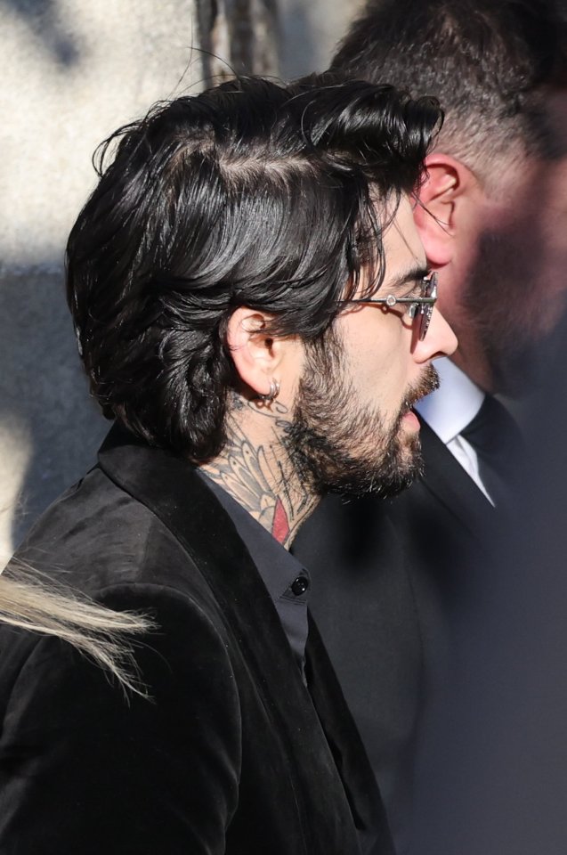 a man with a tattoo on his neck is wearing glasses