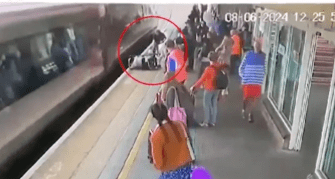 a group of people are standing on a train platform .