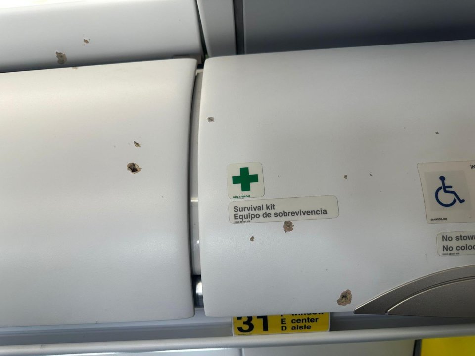 Bullet holes in overhead lockers on the Spirit Airlines plane