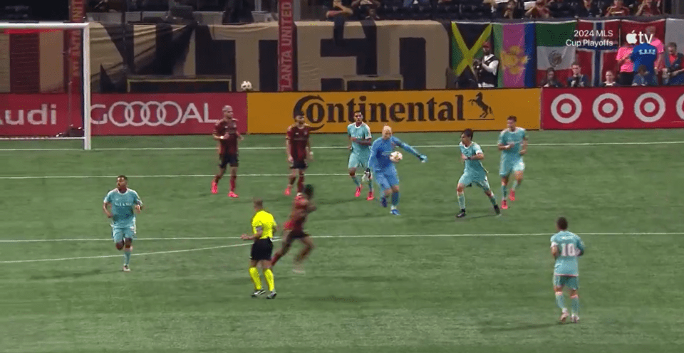 a group of soccer players on a field with an ad for continental in the background