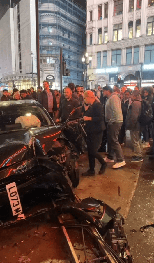 Large crowds had gathered next to the vehicle after the accident