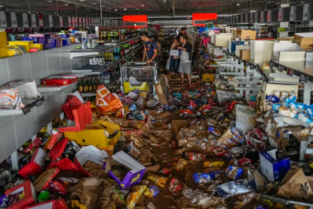 A supermarket in Valencia has been trashed in the floods as people frantically try to find food and drink