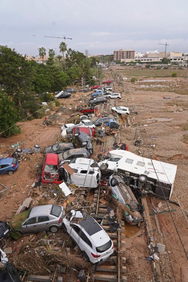 Cars had been strewn across railway tracks after floods on the outskirts of Valencia