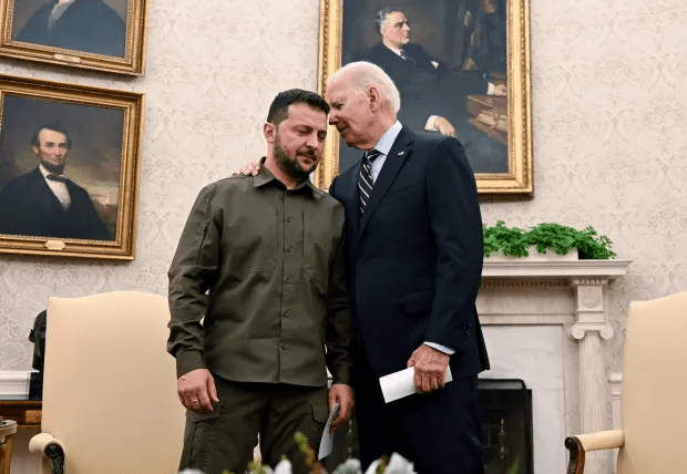 two men are standing next to each other in front of a painting of abraham lincoln