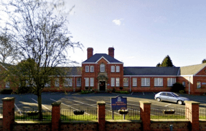 a large brick building with a sign that says ' castle high school ' on it