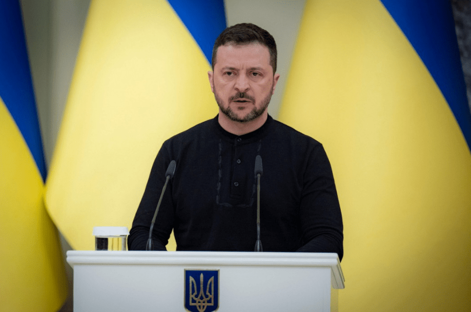 a man stands at a podium with a coat of arms on it