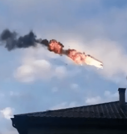 a fire is coming out of a chimney on top of a building