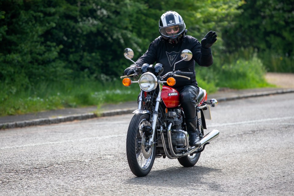 Stoke Goldington,Northants,UK - May 14th 2023. 1977 KAWASAKI Z650 motorcycle travelling through an English village