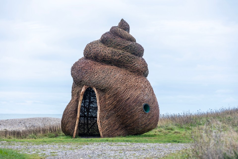 a large sculpture of a sea shell with a hole in the middle