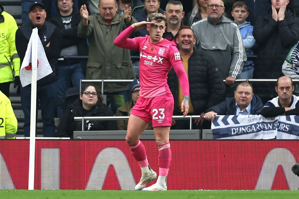 a soccer player wearing number 23 salutes the crowd