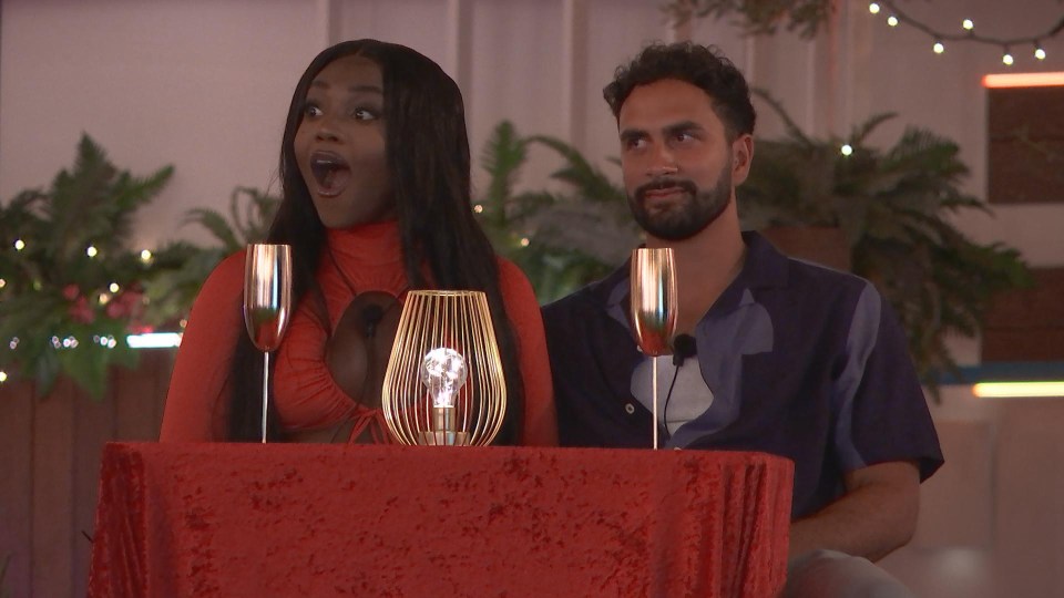 a man and a woman are sitting at a table with wine glasses