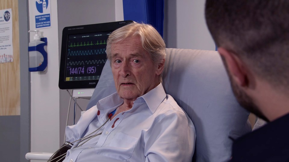 an elderly man in a hospital bed with a monitor that says 144774 on it