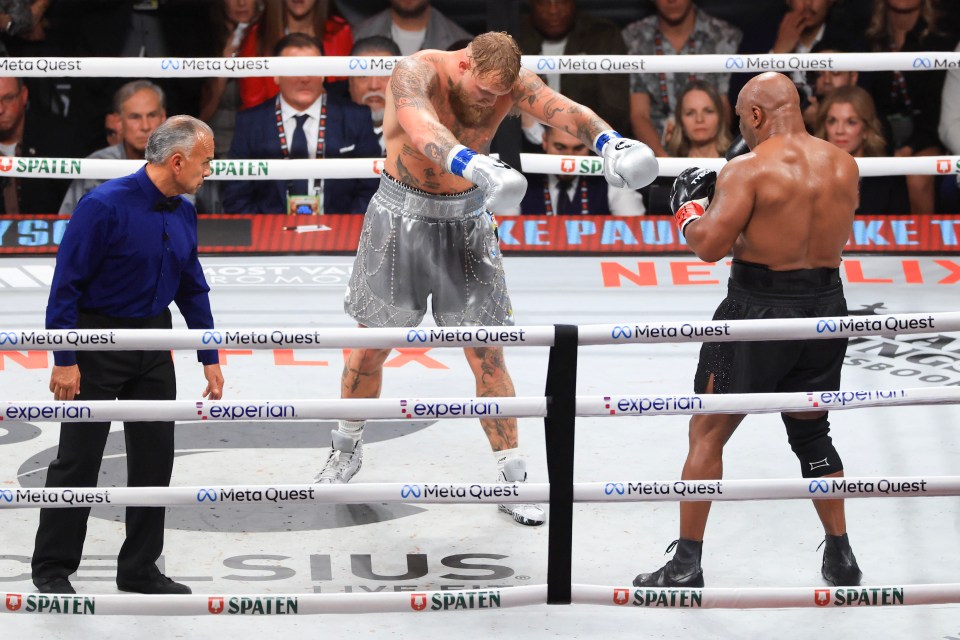 two boxers in a ring with a banner that says meta quest