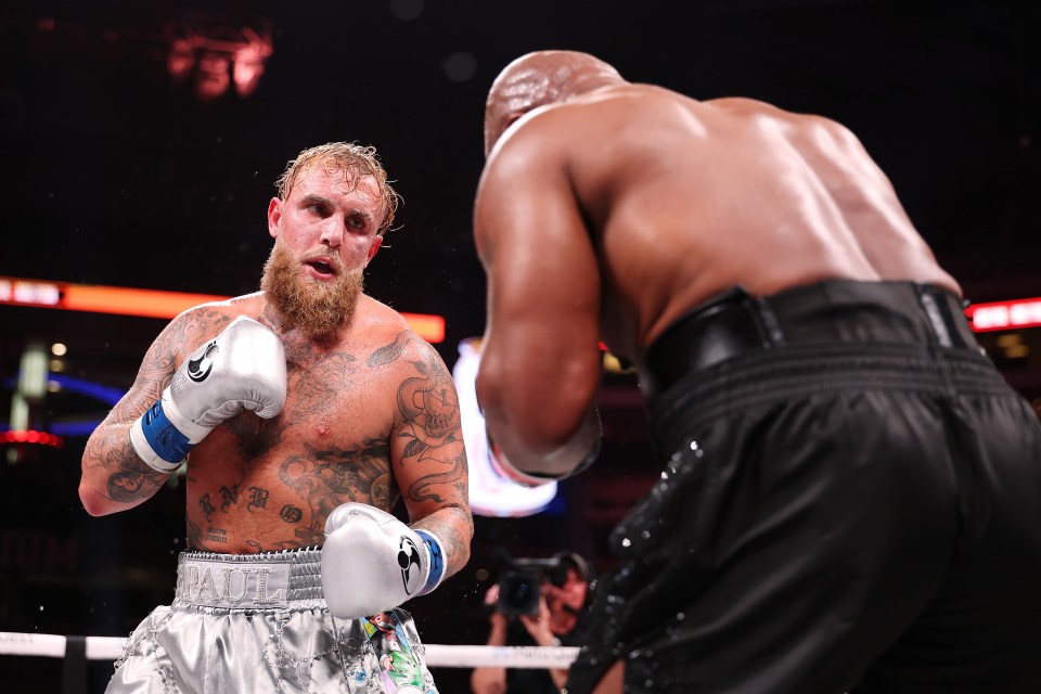 a man in boxing gloves with the word paul on his chest