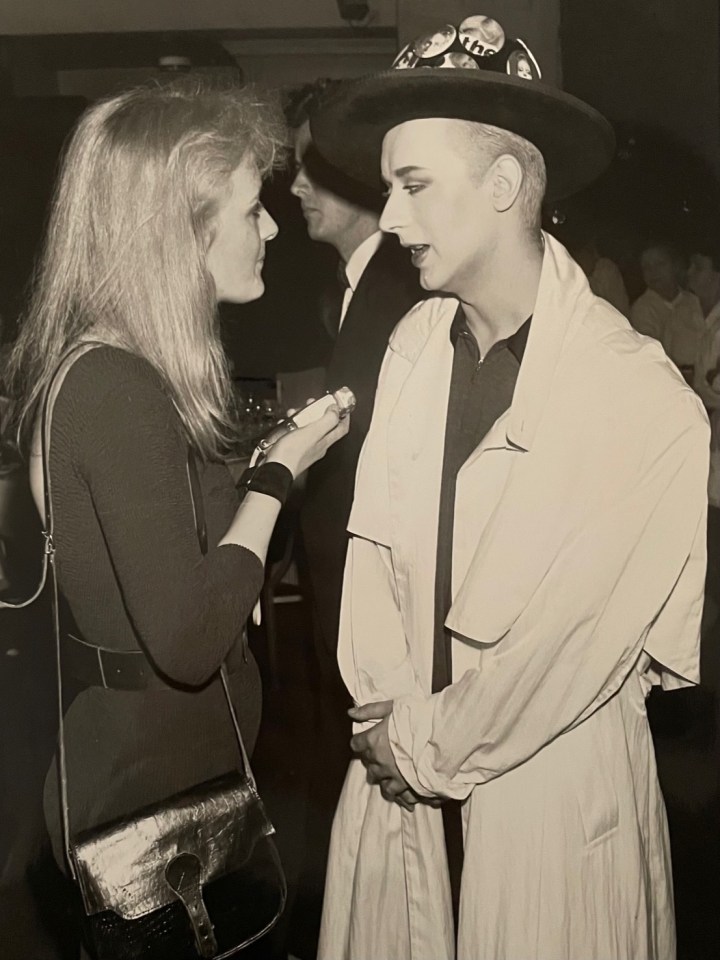 a black and white photo of a woman talking to a man