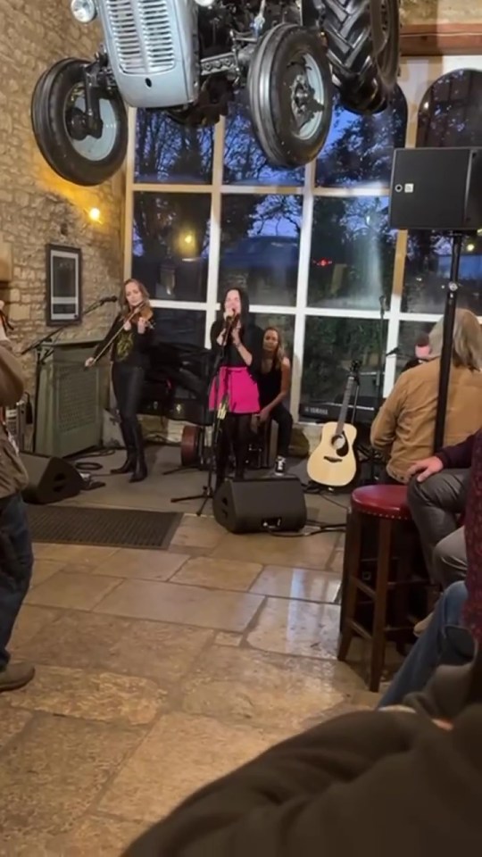 a woman singing in front of a yamaha guitar