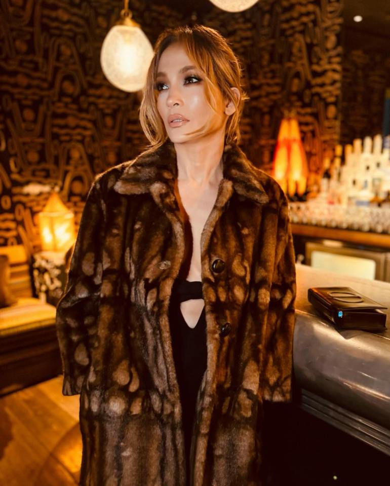 Jennifer wrapped up with a warm brown fur coat in several of the shots