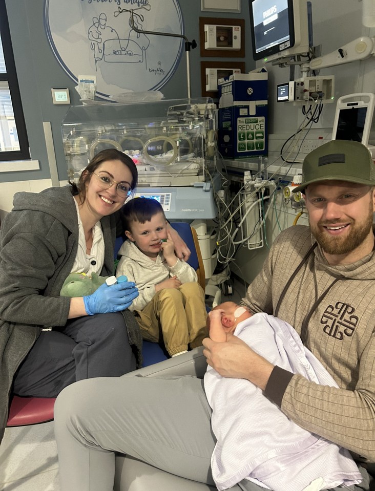 Kate with Blake and Nolan and their father Carl in hospital