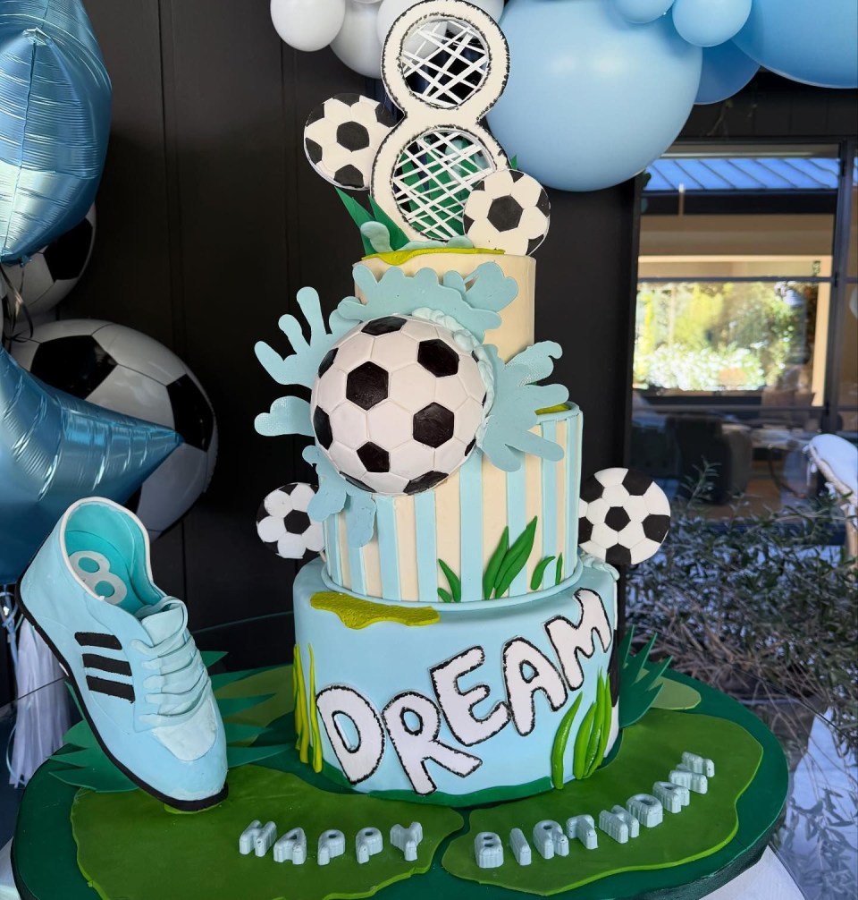 a cake with soccer balls and the word dream on it