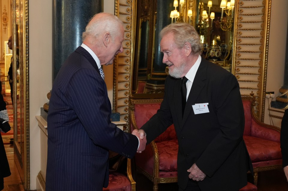 His Majesty shook hands with director Ridley Scott at a star studded Buckingham Palace bash Wednesday evening