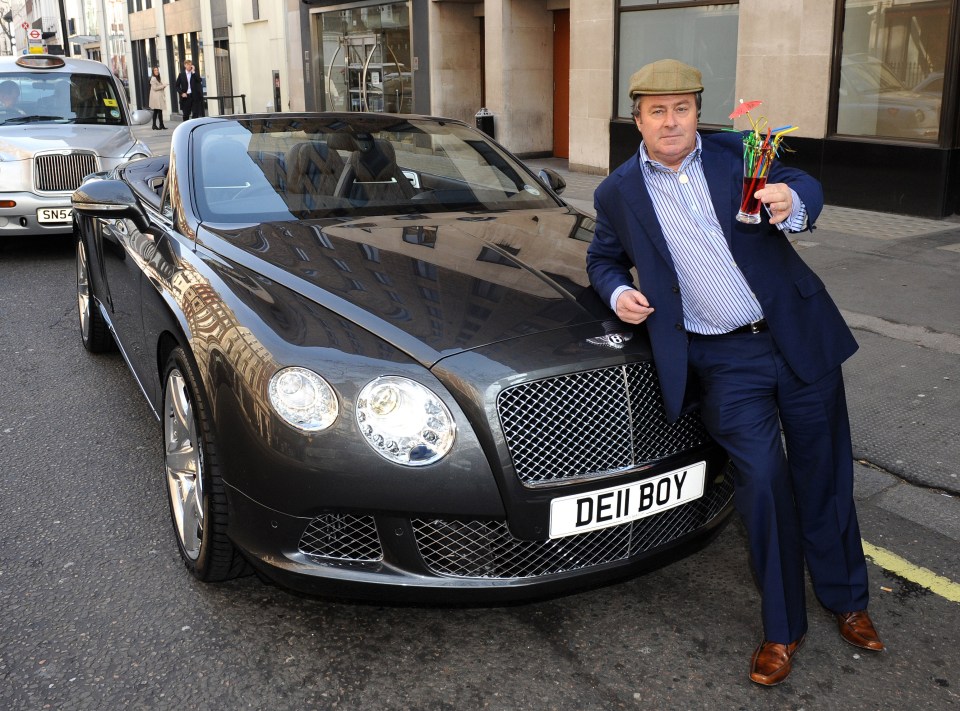 a man stands in front of a bentley with a license plate that says deii boy