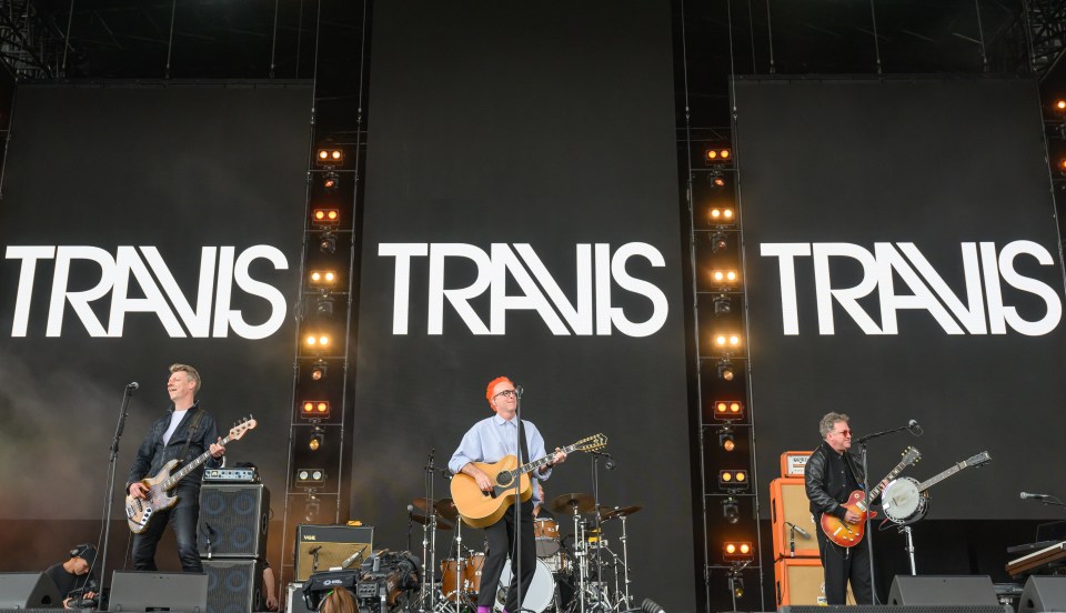 a band called travis is performing on stage