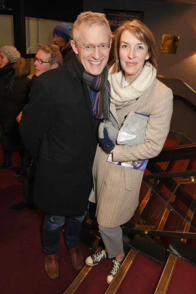 a man and a woman are standing on a set of stairs