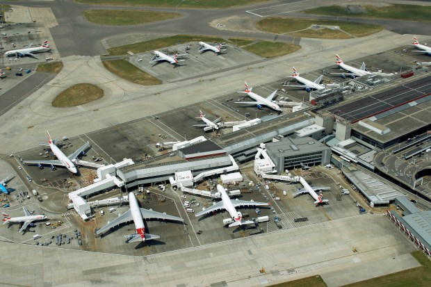 an aerial view of a busy airport with planes parked on the tarmac