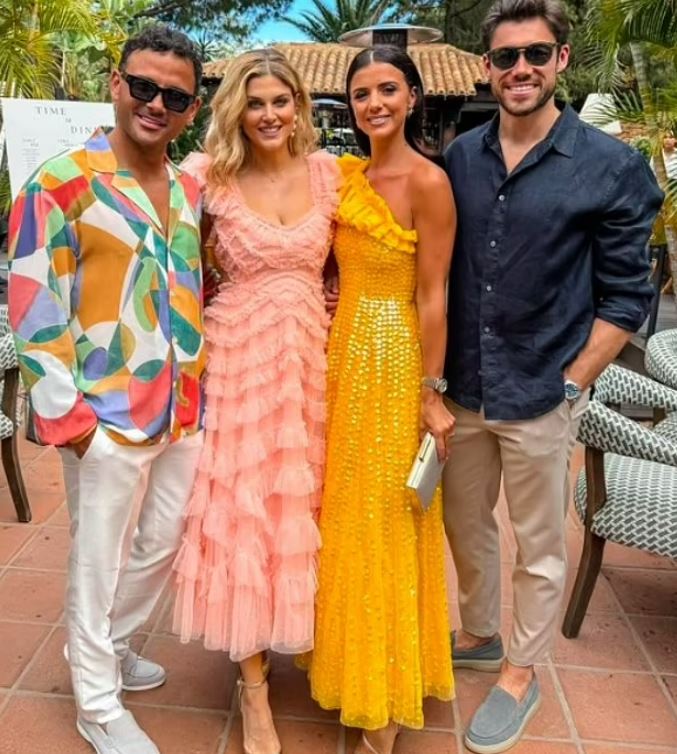 a group of people posing for a picture with one wearing a yellow dress