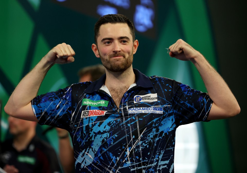 a man flexes his muscles in front of a green background