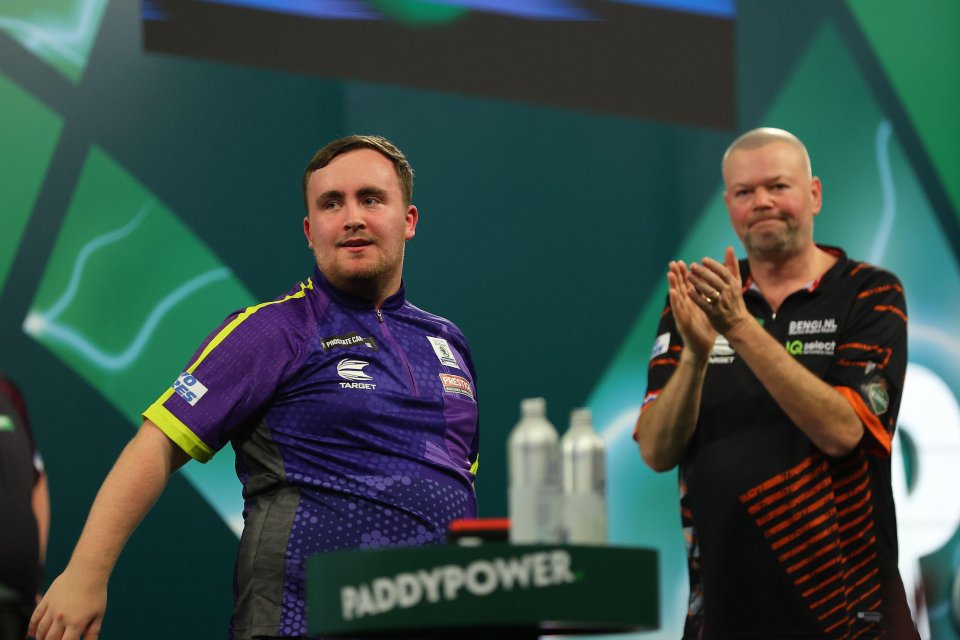 a man in a purple shirt stands in front of a sign that says paddypower