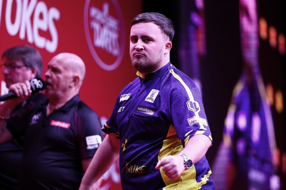 a man in a purple and yellow shirt with the word luke on it