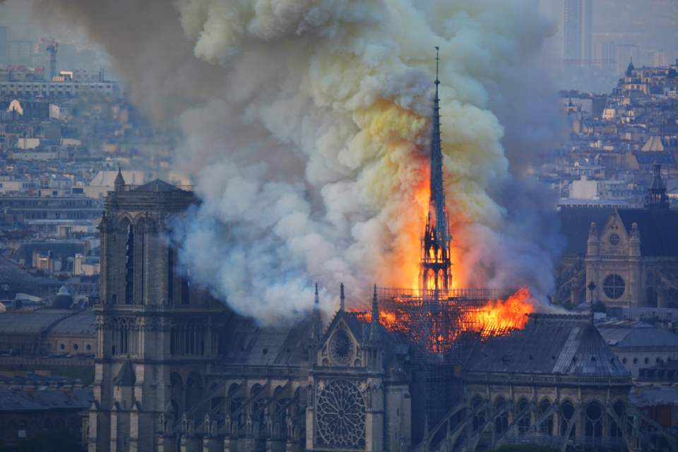 Smoke and flames rise during a fire at the landmark Notre-Dame Cathedral