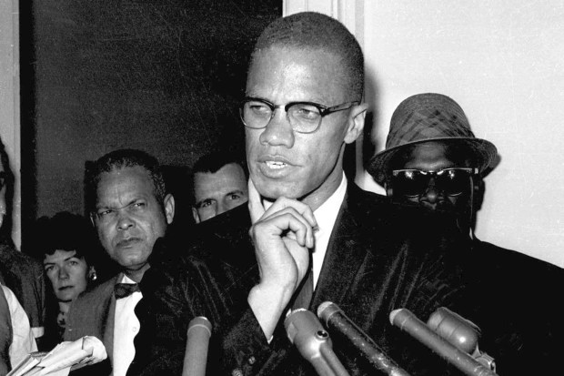 a black and white photo of a man speaking into a microphone