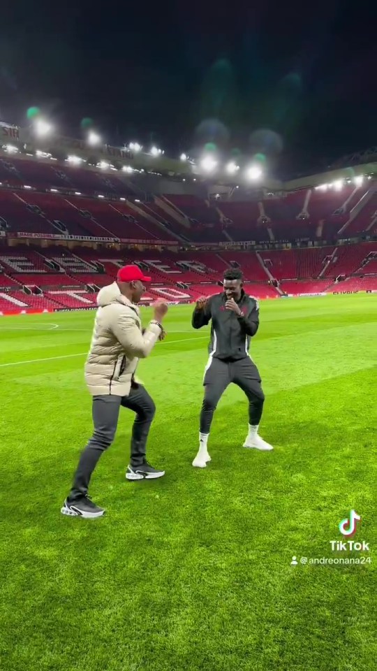 Francis Ngannou and Andre Onana play fight on the Old Trafford pitch