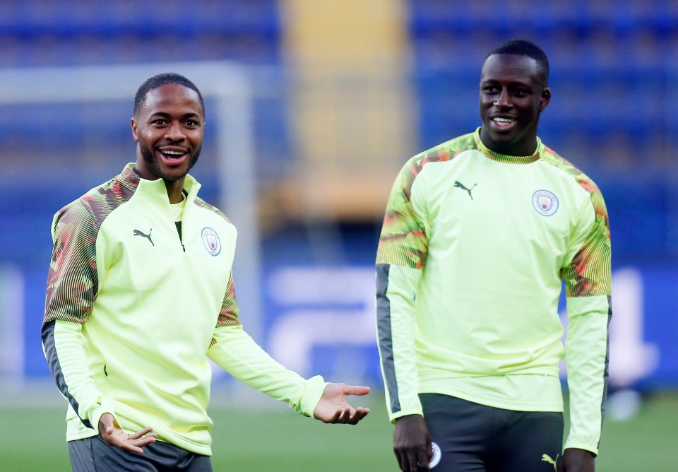 two soccer players wearing yellow sweatshirts with the word city on them