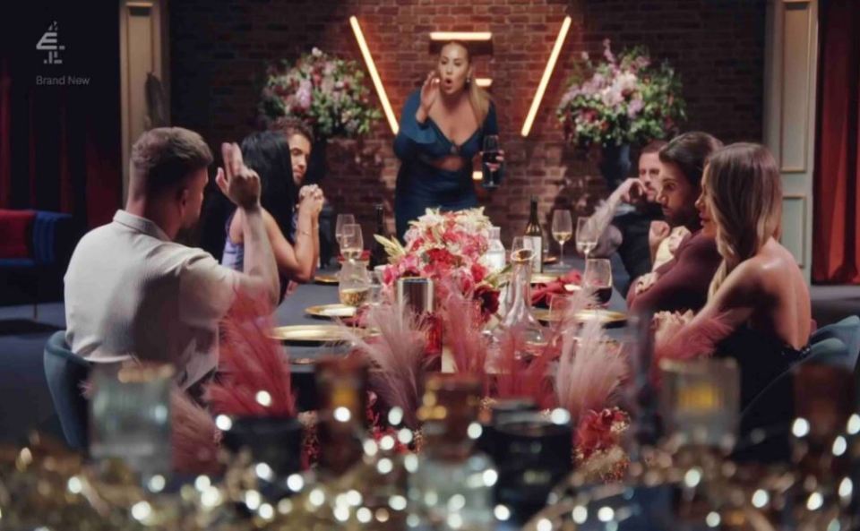 a group of people sitting around a table with a sign that says brand new