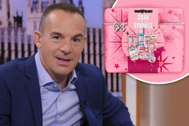 a man in a suit sits next to a pink box that says soak and sparkle