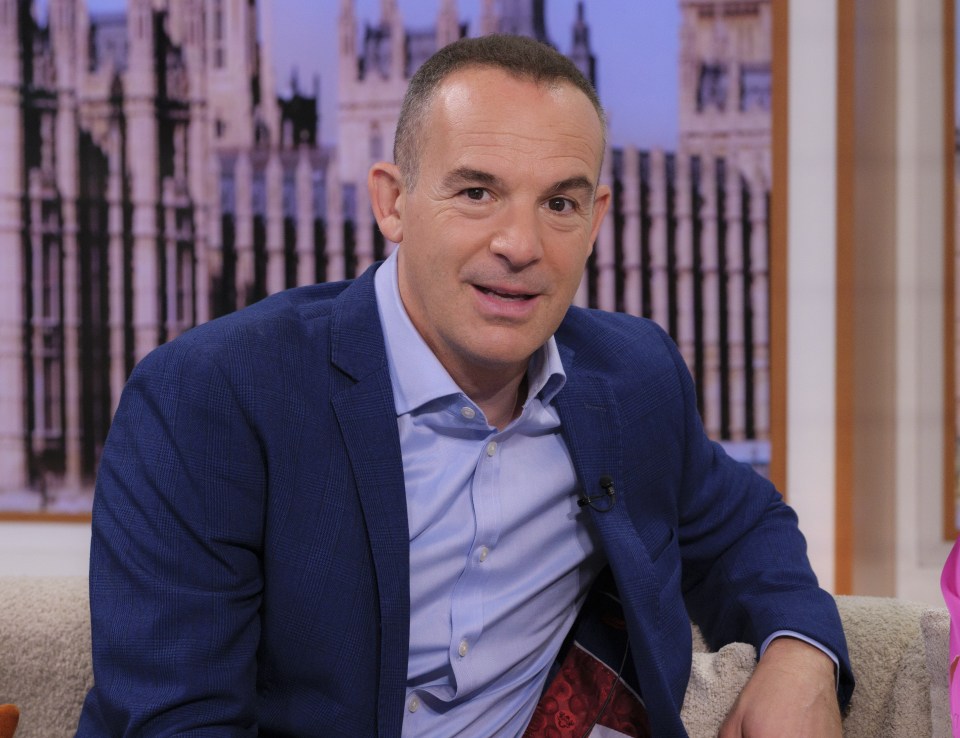 a man in a blue suit is sitting on a couch