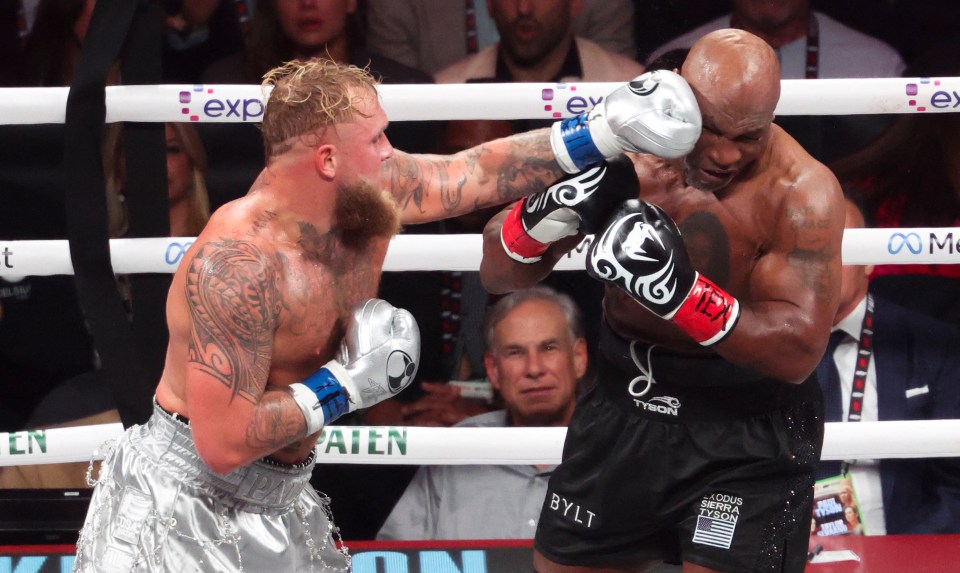 two boxers in a ring with one wearing shorts that say bylt