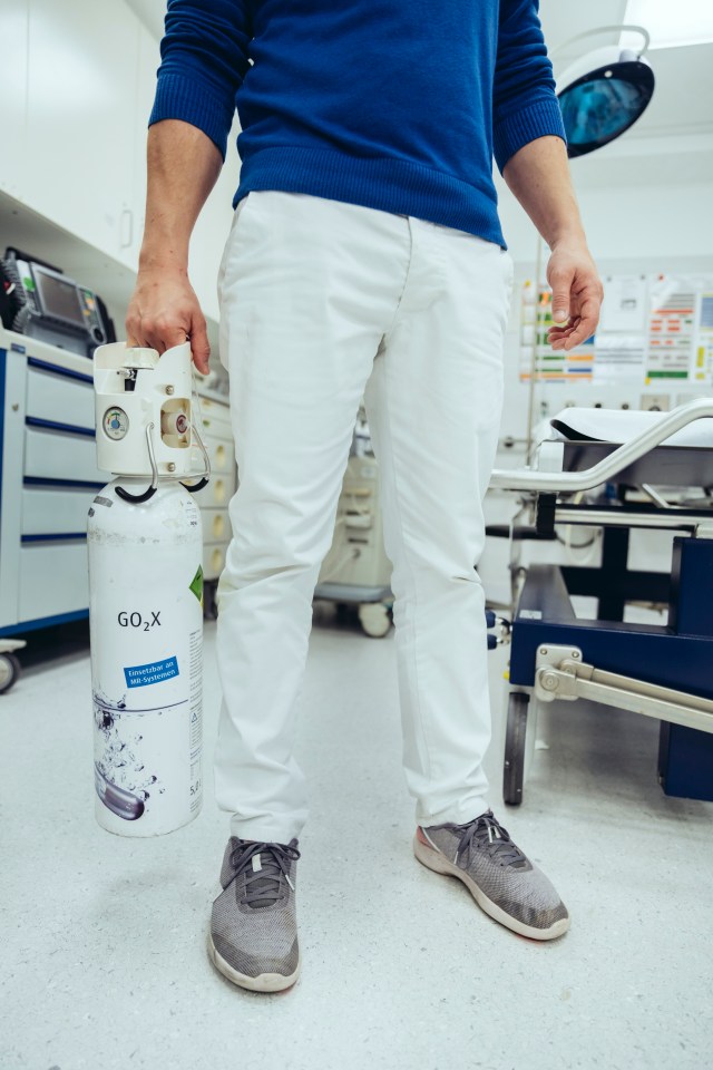 a man holding a cylinder that says go2x on it