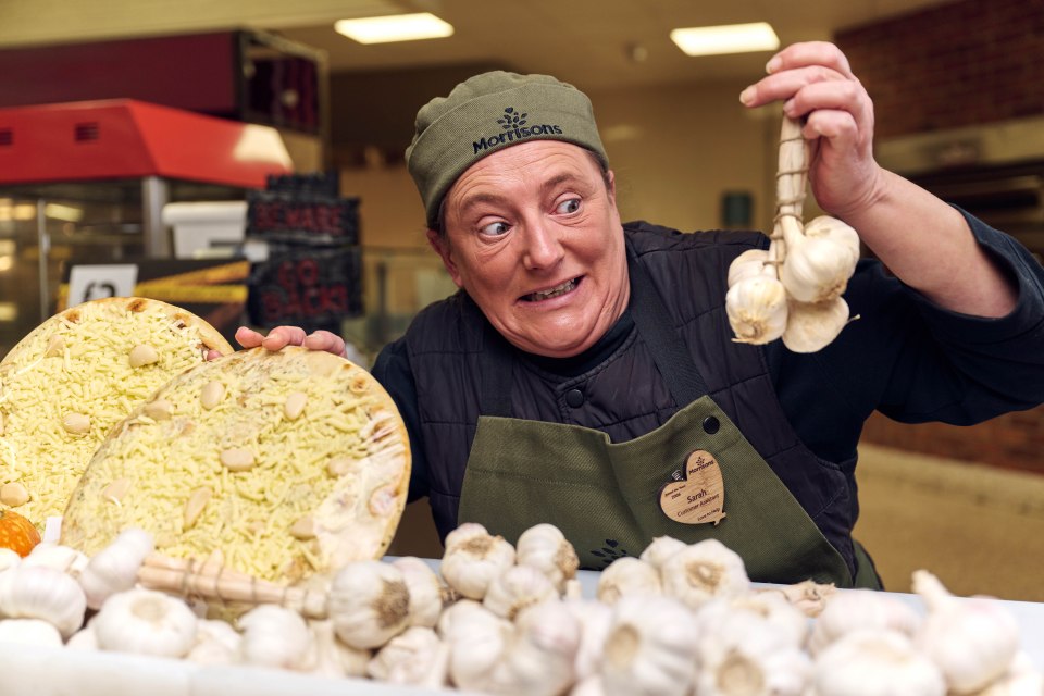 a woman wearing a morton 's hat is holding garlic