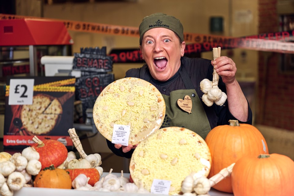 a woman wearing a morton 's hat is holding a pizza