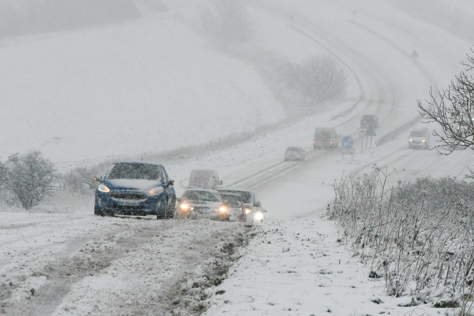 Motorists struggling for grip as heavy snow falls on the A35 at Askerswell in Dorset