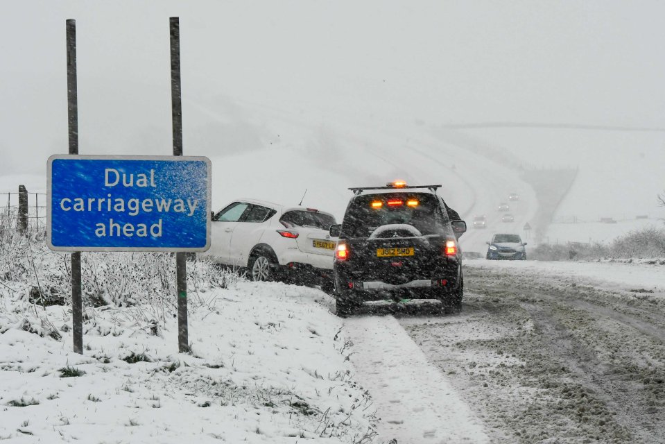 Motorists struggling for grip as heavy snow falls on the A35 at Askerswell in Dorset