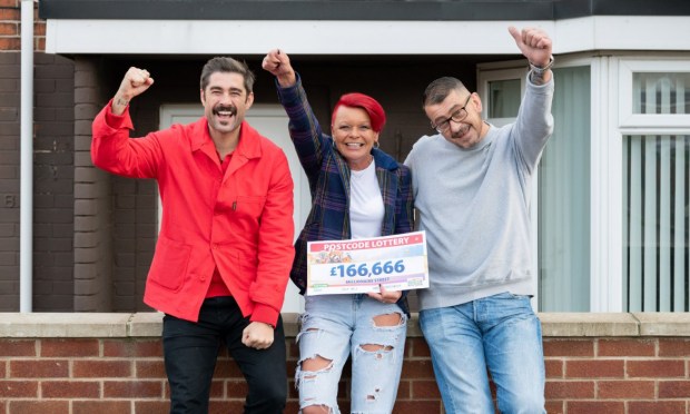 three people holding up a postcode lottery ticket