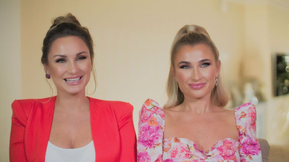 two women are sitting next to each other and smiling for the camera